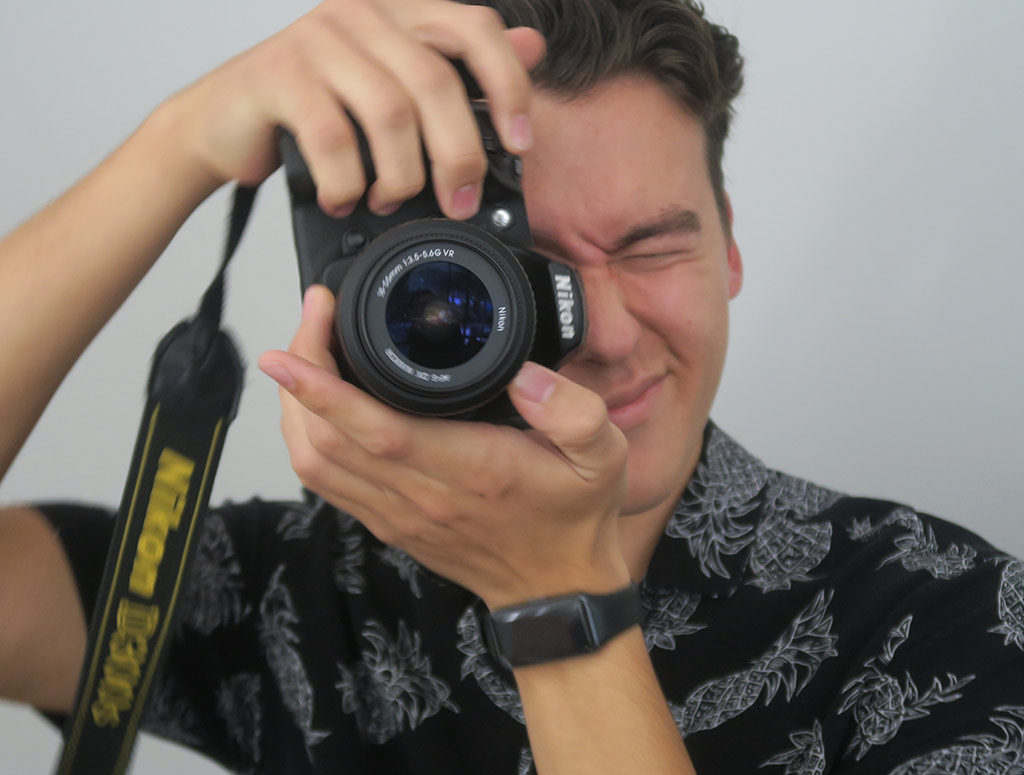 student taking a picture with a camera