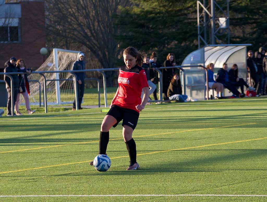 una estudiante universitaria juega a fútbol
